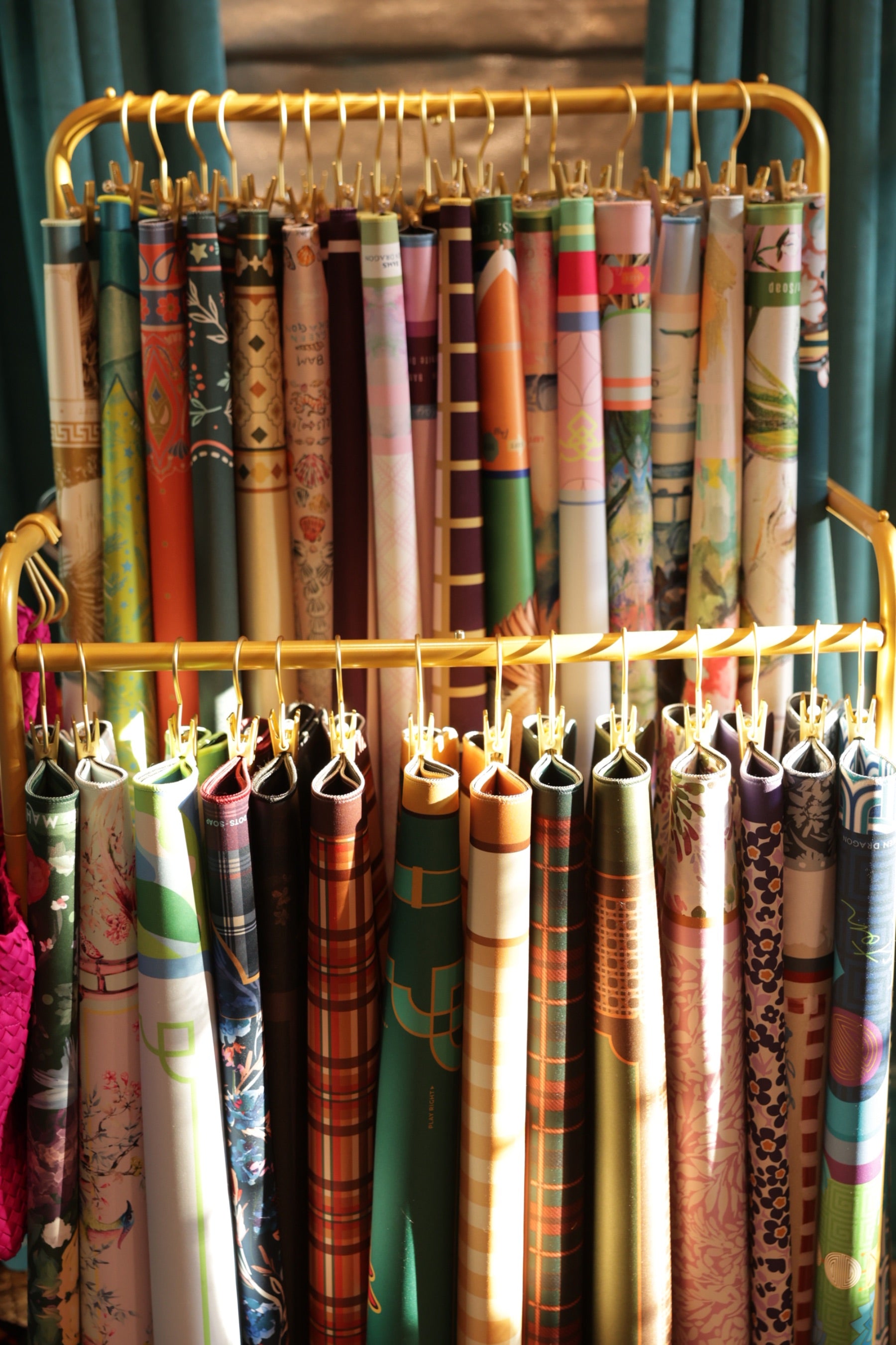 Mahjong mats hanging on a gold rack